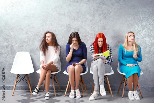Young girls sitting on a ch...