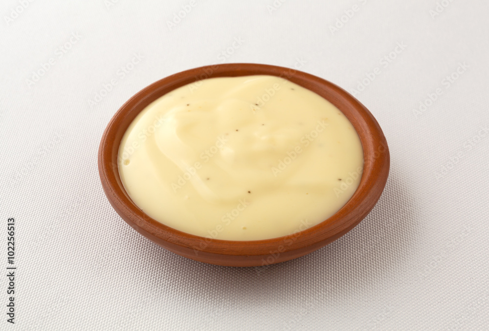 Bowl of blue cheese salad dressing on tablecloth Bowl of blue cheese salad dressing on tablecloth