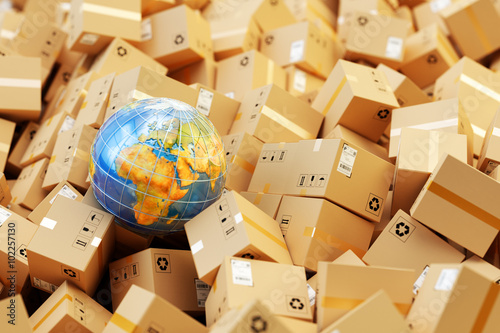 Distribution warehouse, international package shipping, global freight transportation business, logistics and delivery concept, background with heap of cardboard boxes, parcels and Earth globe photo