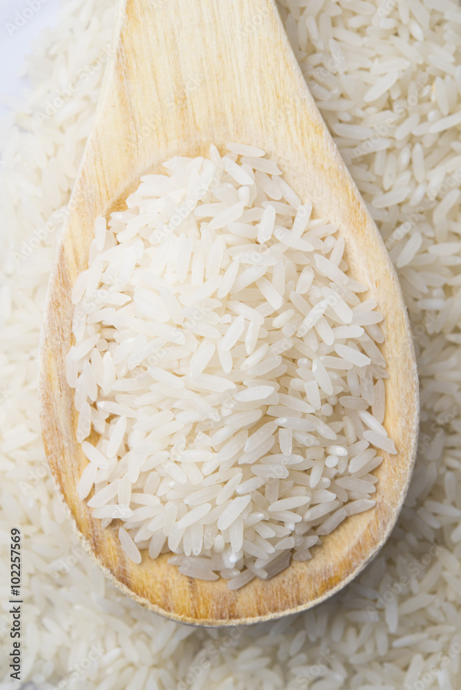 food background. brown rice in a wooden spoon. top view food background. brown rice in a wooden spoon. top view