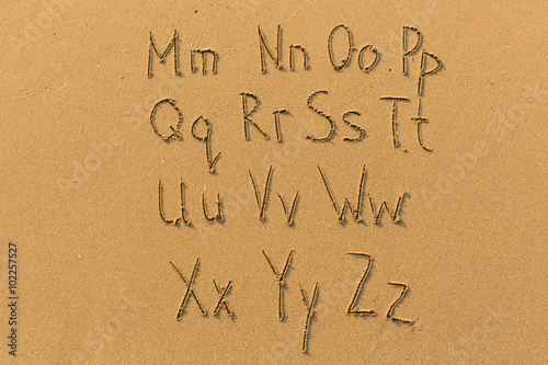 Alphabet drawn on the sand of a beach. (part two of two - from Mm to Zz) photo