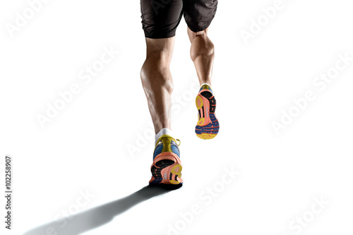 strong athletic legs with ripped calf muscle of young sport man running isolated on white background