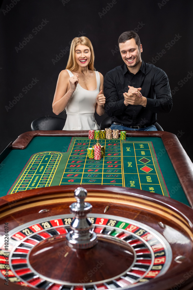 Couple playing roulette wins at the casino. Couple playing roulette wins at the casino.