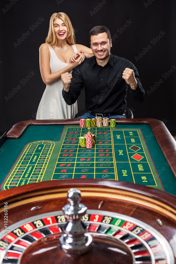 Couple playing roulette wins at the casino. Couple playing roulette wins at the casino.