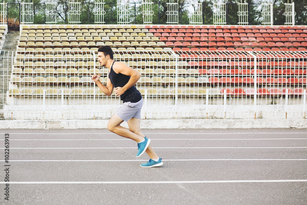 Fototapeta premium Man running on a racing track