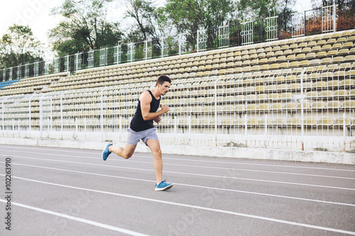 Man running on a racing track