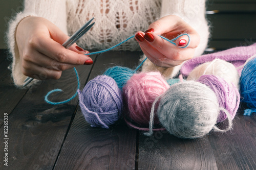 woman hands knitting with stylish knitting needles