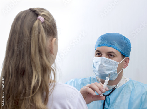 Doctor in his practice with syringe photo