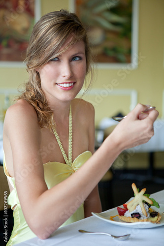 Pretty Woman Eating Dessert in Fancy Restaurant