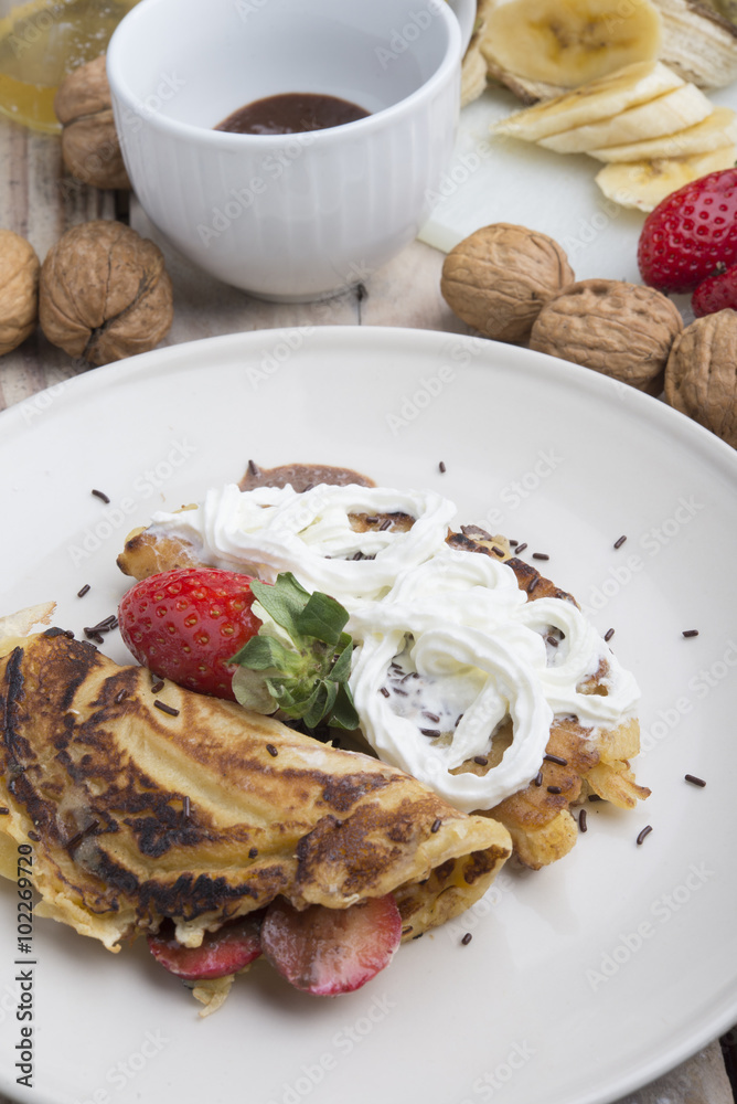 delicious crepes with berries and chocolate sauce, closeup
