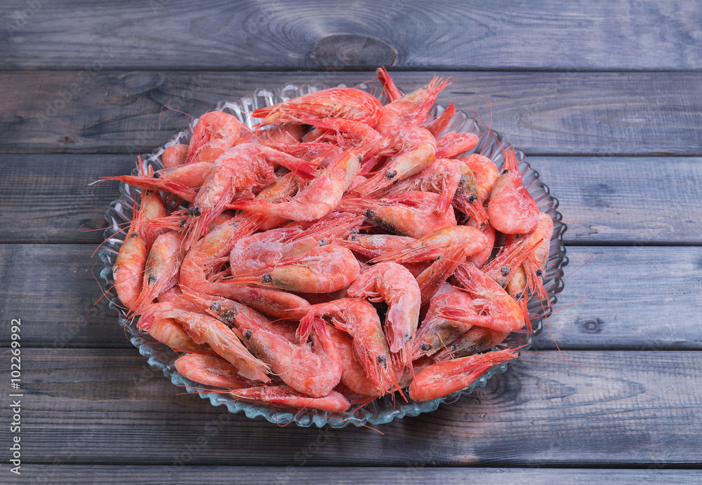 Large glass dish with a large frozen shrimp Large glass dish with a large frozen shrimp