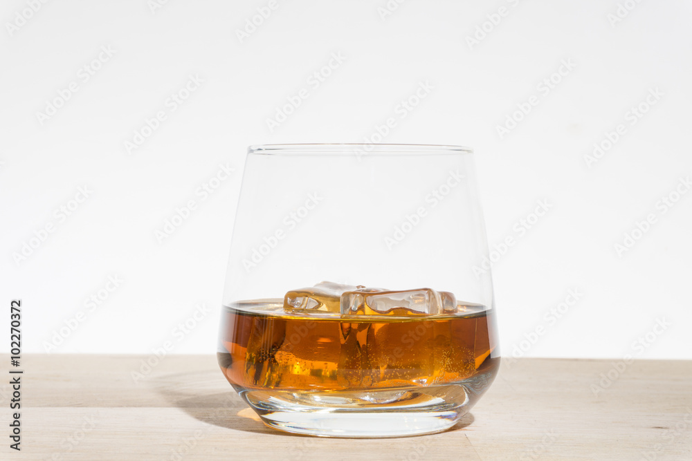 iced wiskey on the wood floor white backround iced wiskey on the wood floor white backround