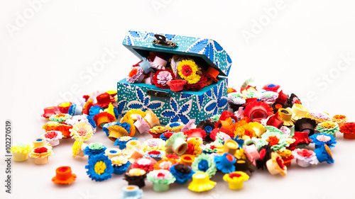 Small, colorful paper flowers made with quilling technique and wooden painted box