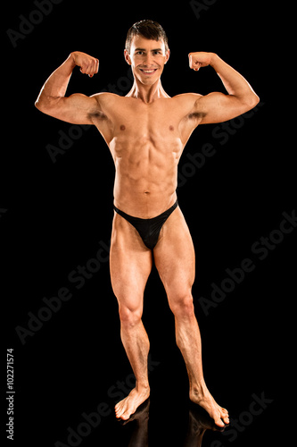 Bodybuilder Posing on Black