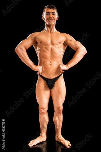 Bodybuilder Posing on Black