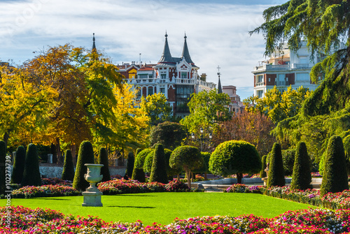 Gardens and green space in Park of Madrid, Spain on a blue-sky sunny day.  Citizens and tourists alike enjoy the gardens on a fabulous warm November day. © valleyboi63