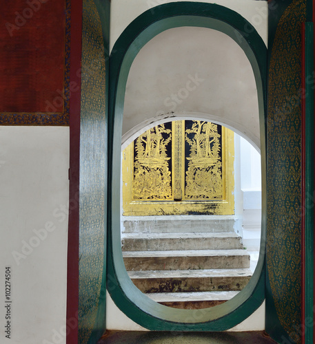 old wooden Church Door in Wat Phrapathom Chedee Thailand photo