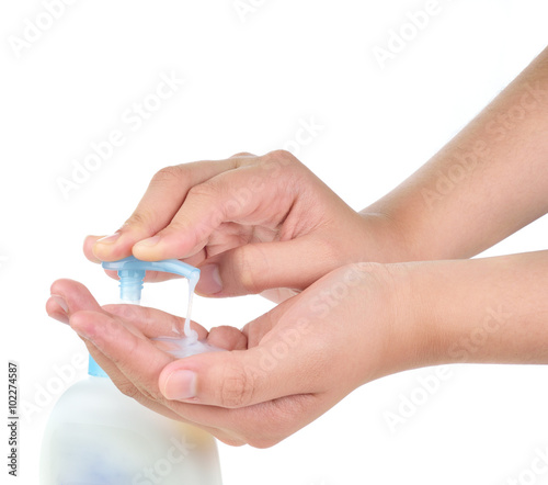 woman applying cream on hands on white background