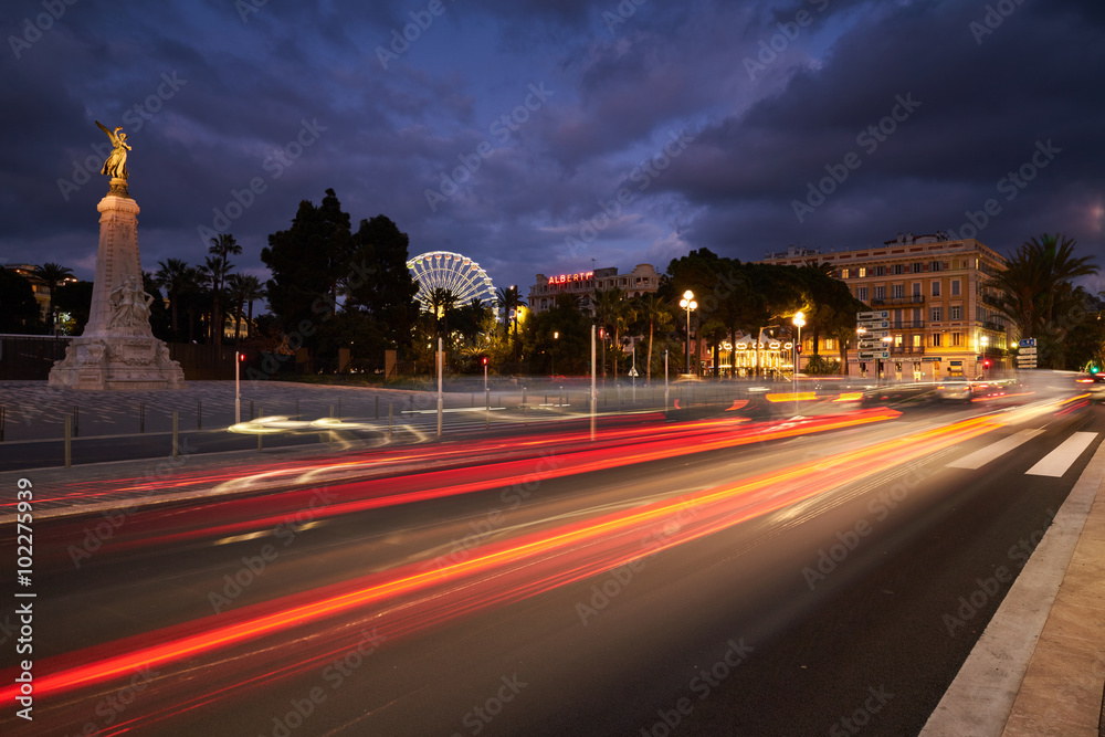 Naklejka premium France, Nice, 2016.01.21: Monument Centennial, Promenade des Anglais, traffic, long exposure, Great wheel on the place Massena (Massena square), 