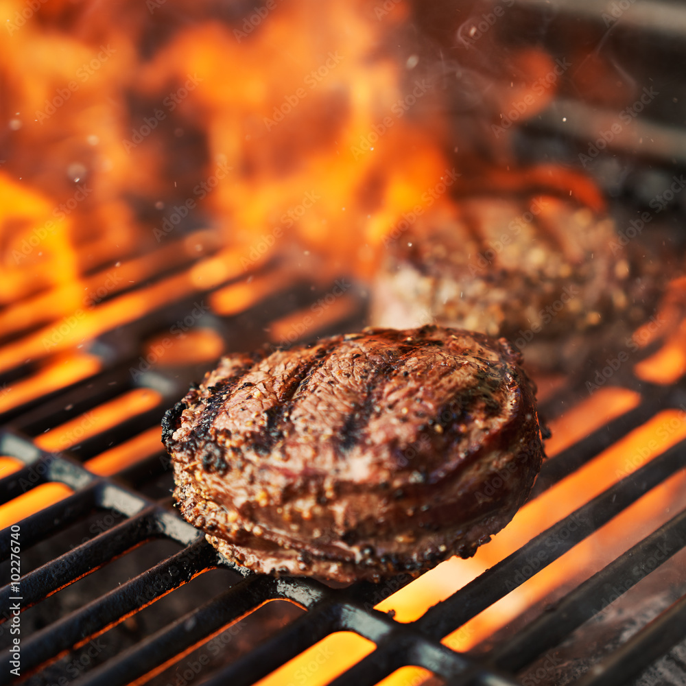 grilling filet mignon steaks on grill with flames Stock Photo Adobe Stock