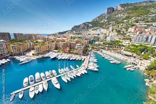 Monaco, Fontvieille, 29.08.2015: Port Fontvieille, panorama, topview from Monaco Ville, azur water, sun reflections on the water, harbor, sunny day, luxury apartments, yachts, rocks photo