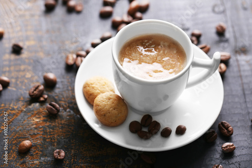 Cup of coffee on wooden table background