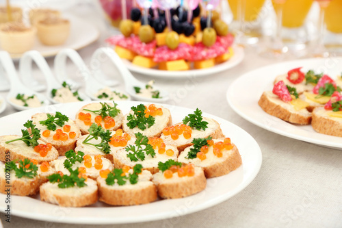 Set of cold snacks, canape, beverages, closeup