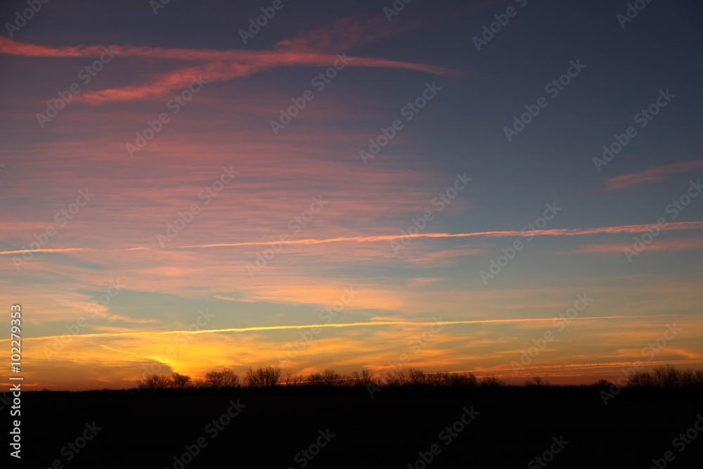 Obraz premium Sunrise with Jet Contrails