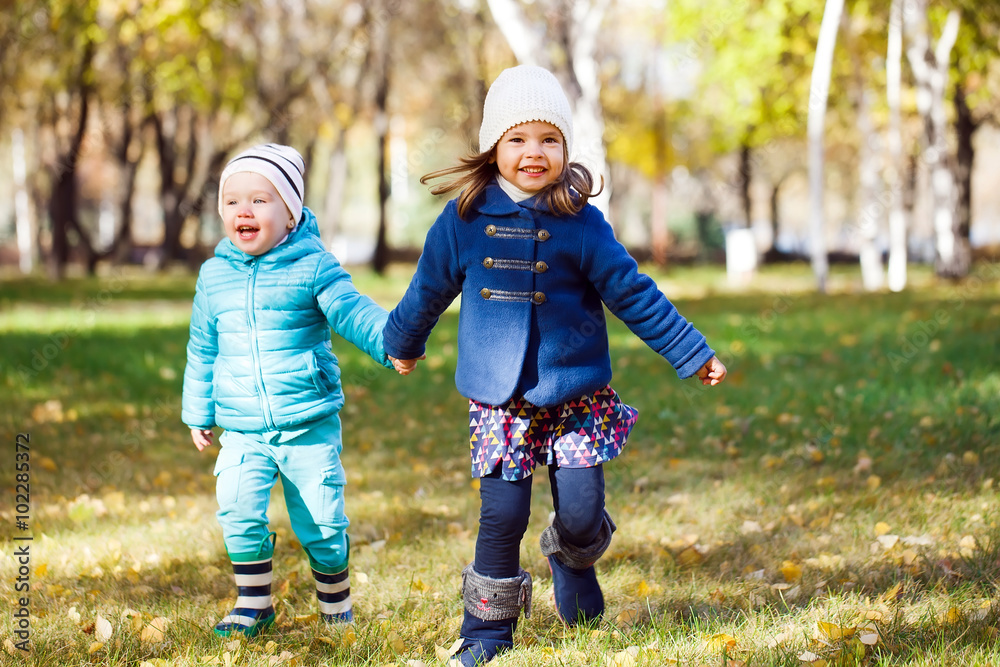 Little girls running in autumn park Little girls running in autumn park