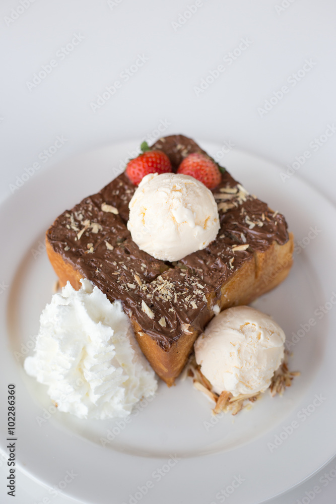 Fresh Toast with chocolate spread on a white plate with icescrea Fresh Toast with chocolate spread on a white plate with icescrea