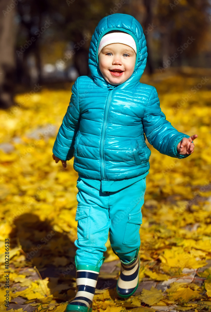 Little girl playing in autumn park Little girl playing in autumn park