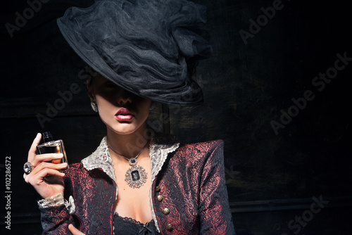 Girl in a hat trying fresh perfume