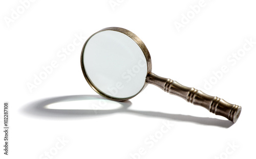 Round metal magnifying glass with a shadow