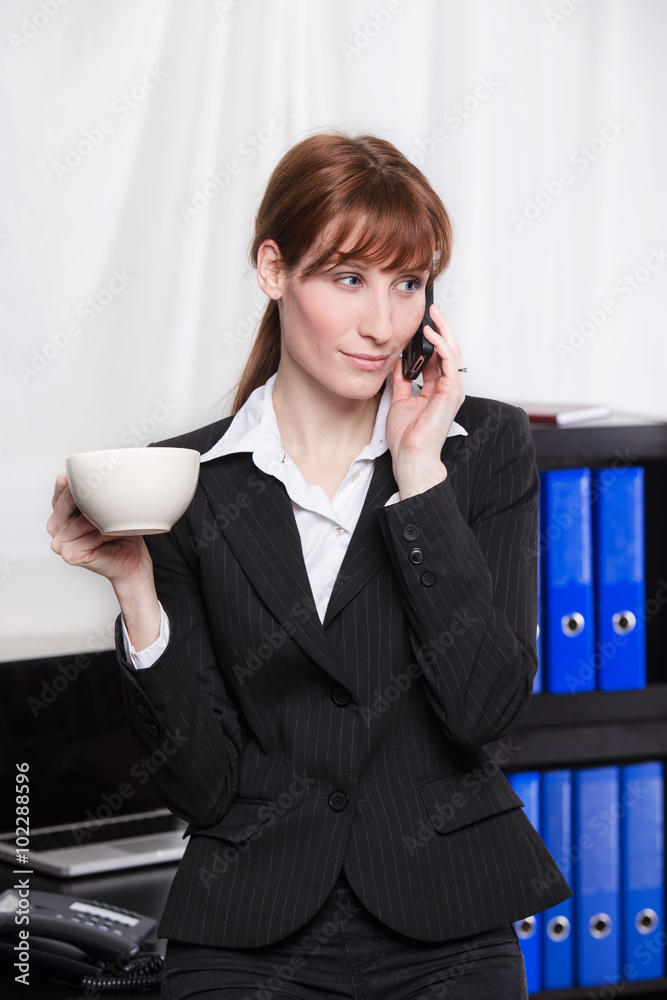 business woman drinking coffee and talking on mobile phone business woman drinking coffee and talking on mobile phone
