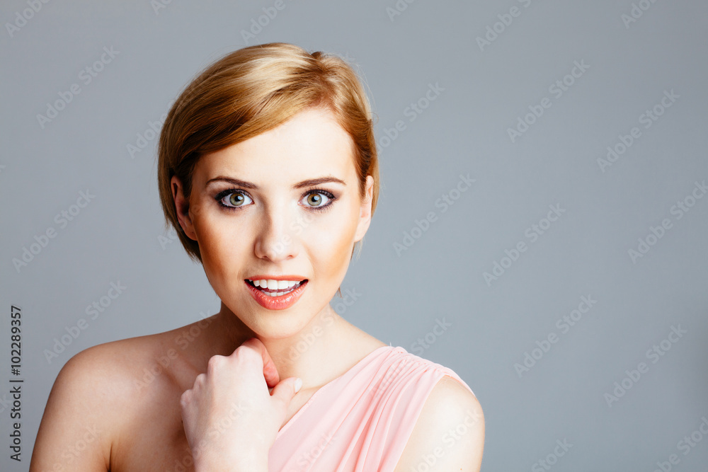 Portrait of beautiful young woman isolated on gray background Portrait of beautiful young woman isolated on gray background