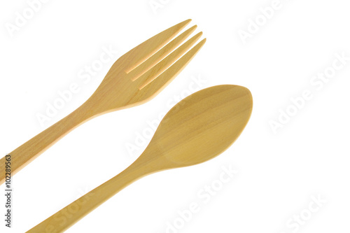 Brown wooden spoon and fork on white