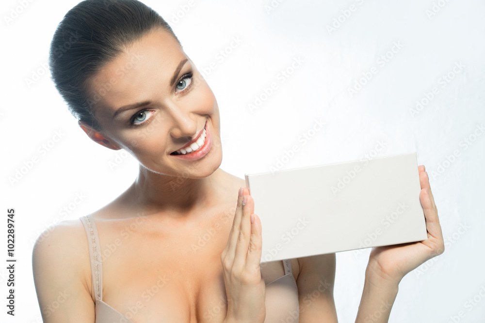 Woman with clean face shows the blank form for the inscription Woman with clean face shows the blank form for the inscription