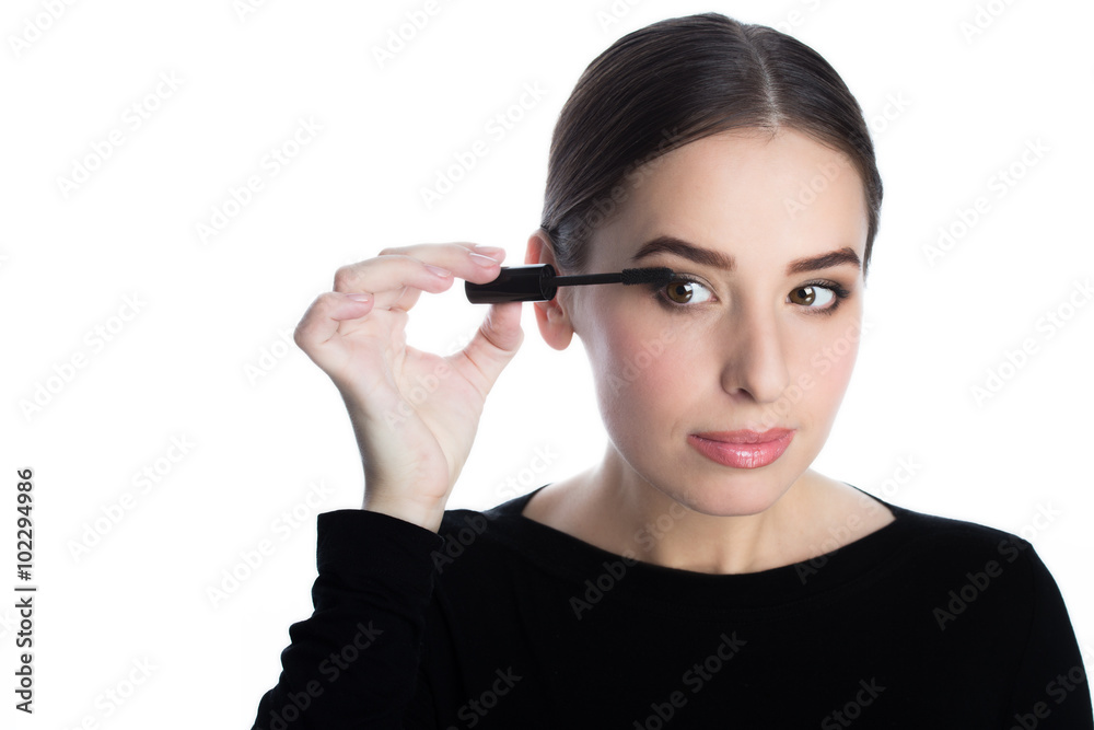 Beautiful young woman applied mascara, studio beauty portrait Beautiful young woman applied mascara, studio beauty portrait