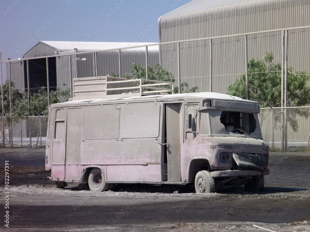 dusty abandoned autobus wreck at a factory