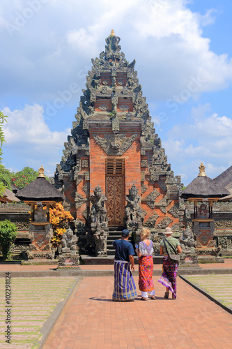 Guide and tourists in ancient temple