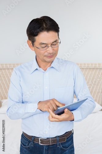 Serious man using tablet