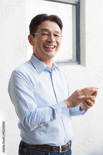 Smiling man using smartphone