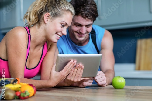 Healthy couple looking at tablet