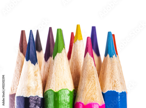 close up of coloured pencil tips on white background