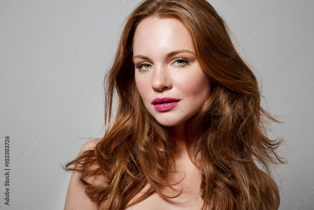 Naklejka premium Beauty Woman Portrait. Healthy Long Red Hair and perfect holiday