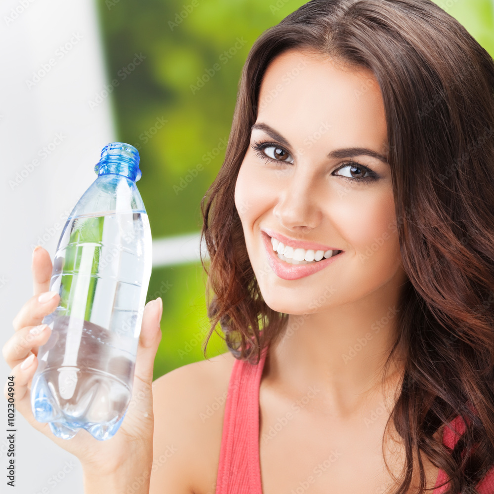 Portrait of young cheerful woman with bottle of water Portrait of young cheerful woman with bottle of water