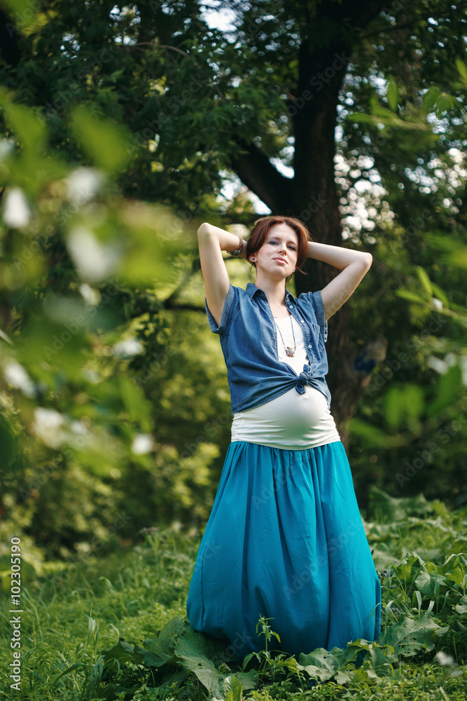 Young Pregnant Woman in the Summer Park Young Pregnant Woman in the Summer Park