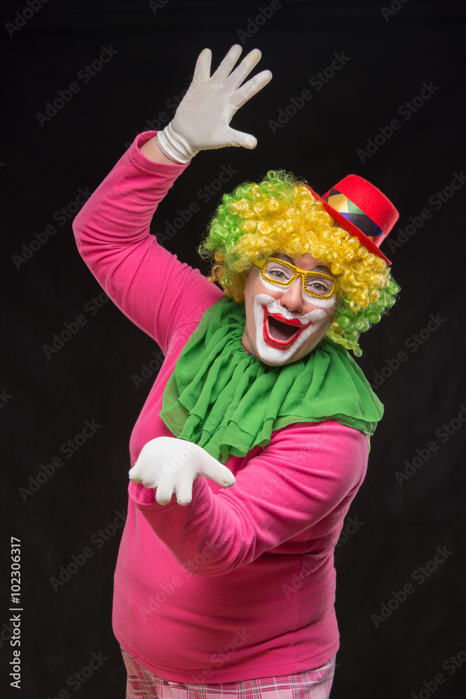 Funny curly clown in shiny glasses with good cheerful emotions Funny curly clown in shiny glasses with good cheerful emotions