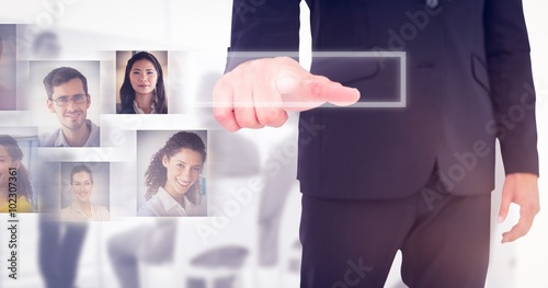 Composite image of businessman pointing with finger