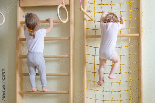  baby toddlers climbing up the stairs.